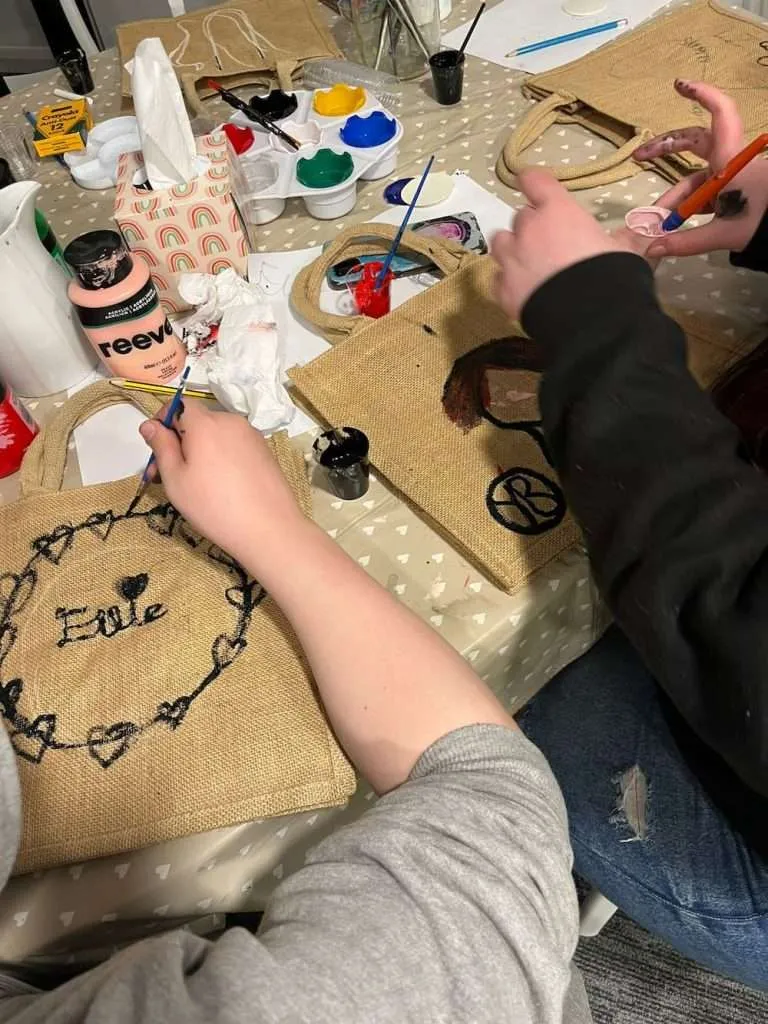 People paining memory bags